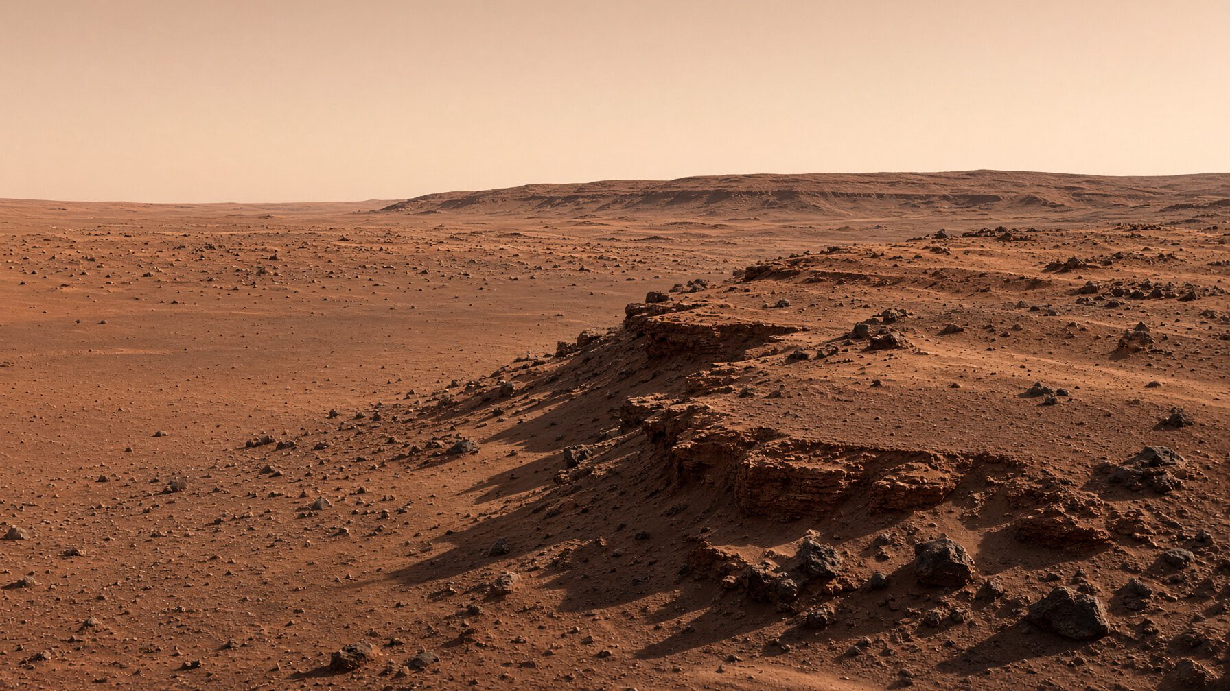 Thessaly Bench: a layered shelf of rusty regolith stepping down to a lower plain under a butterscotch sky.